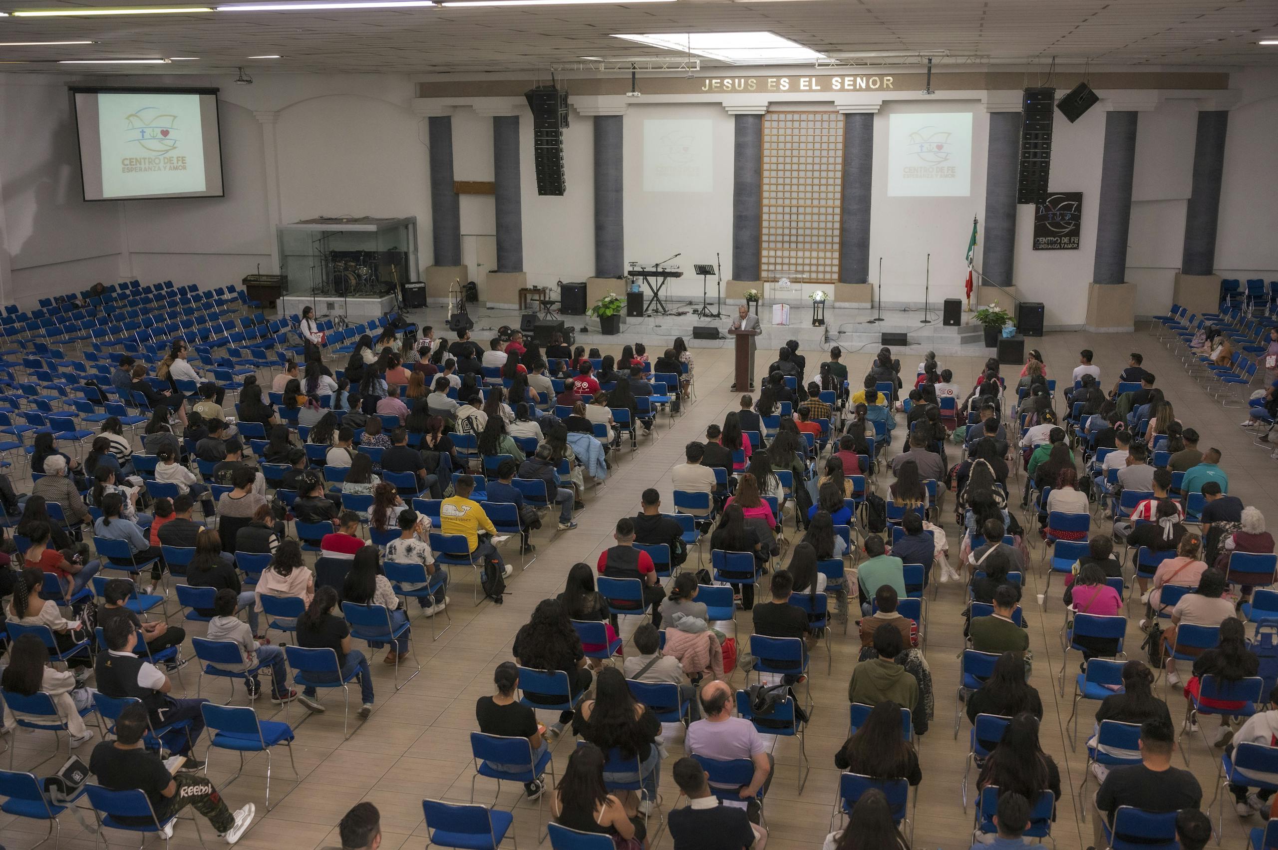 A large crowd of people sitting in chairs in a room